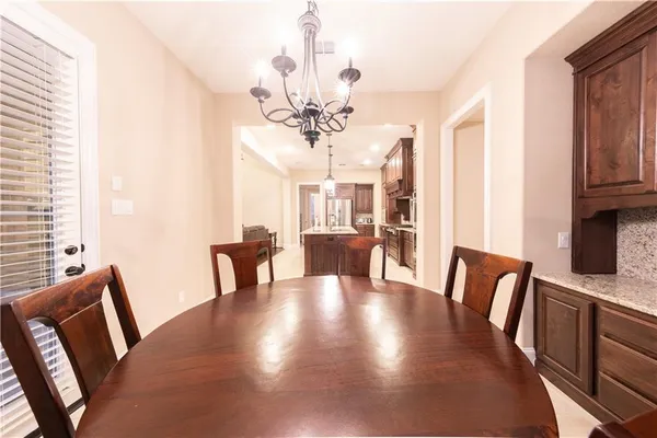 a view of a dining room with furniture and chandelier