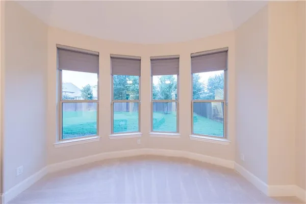 a view of an empty room with windows