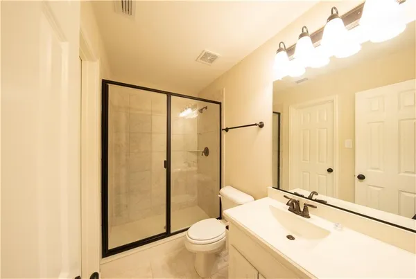 a bathroom with a sink toilet mirror and shower