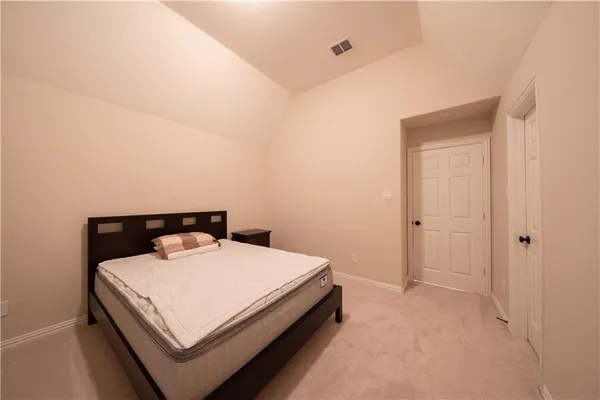 a room with a bed and small table