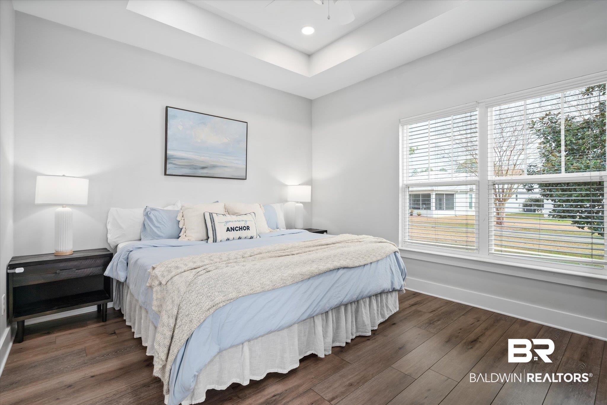 8056 Carmel Circle Foley, AL 36535 - Photo 12 of 28 Bedroom featuring dark hardwood / wood-style floors and a raised ceiling