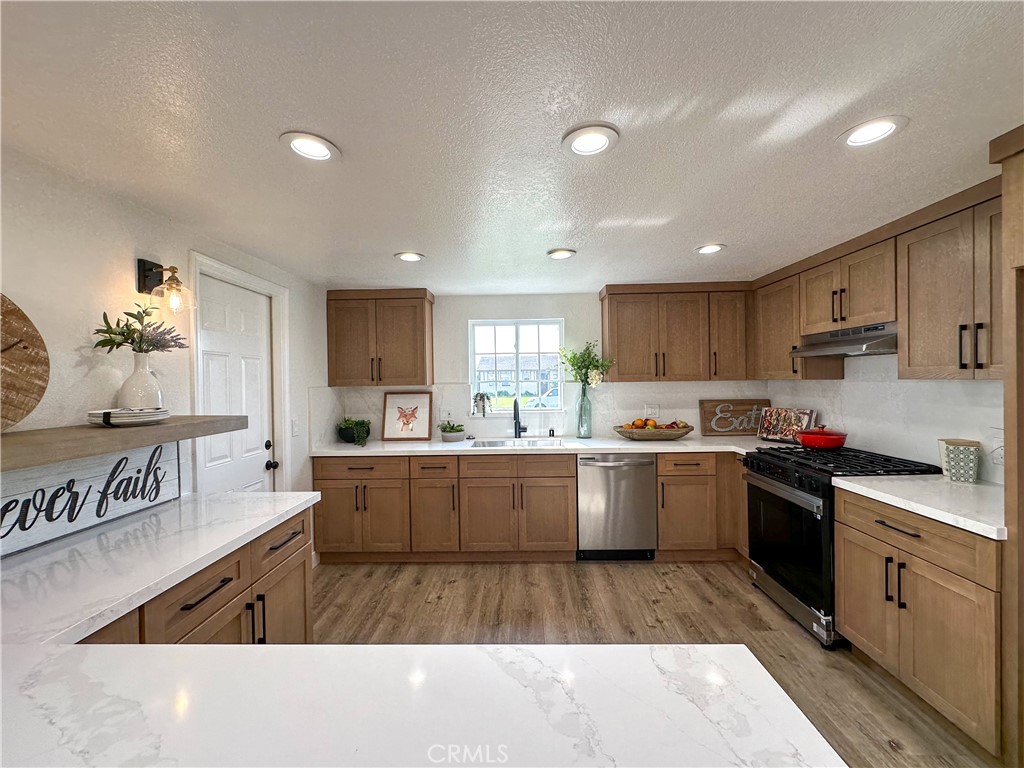 2749 East Everett Place Orange, CA 92867 - Photo 1 of 52 a kitchen with stainless steel appliances granite countertop a sink counter space and cabinets