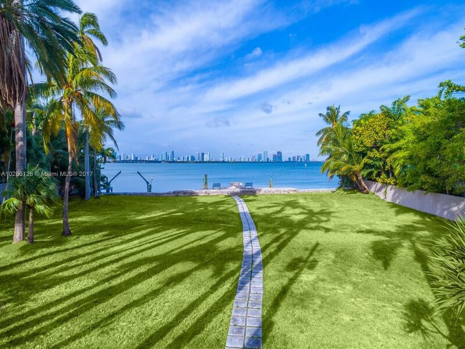 4462 North Bay Road Miami Beach, FL 33140 - Photo 4 of 6 a view of a swimming pool with a yard