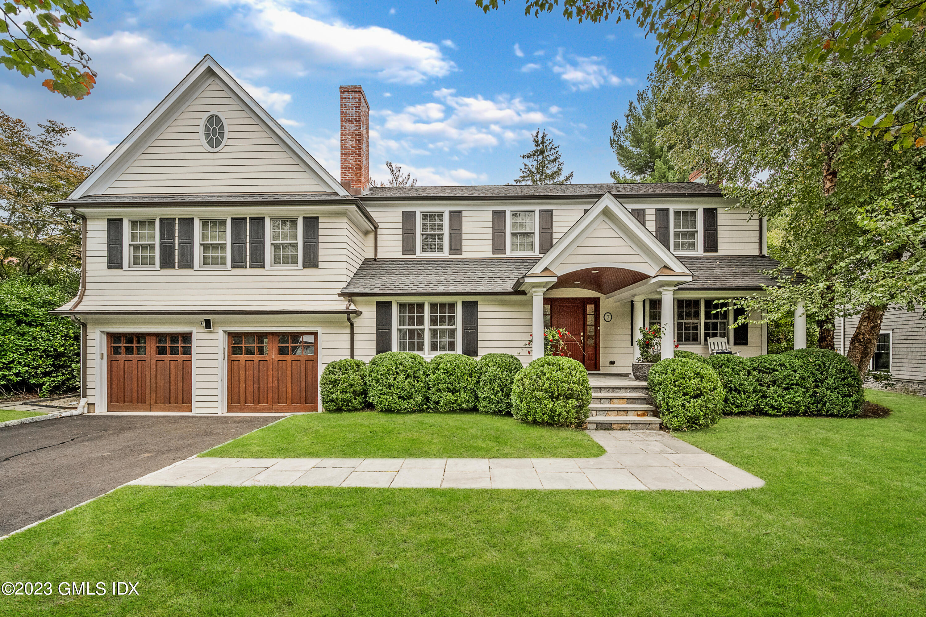 7 Colonial Lane Riverside, CT 06878 - Photo 1 of 27 a front view of a house with a yard