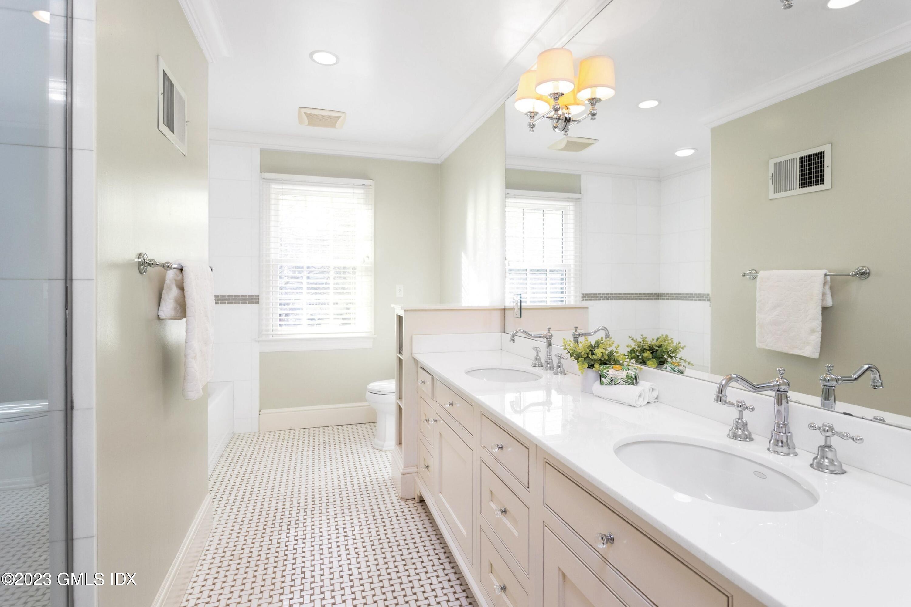 7 Colonial Lane Riverside, CT 06878 - Photo 14 of 27 a bathroom with a double vanity sink a mirror and a shower