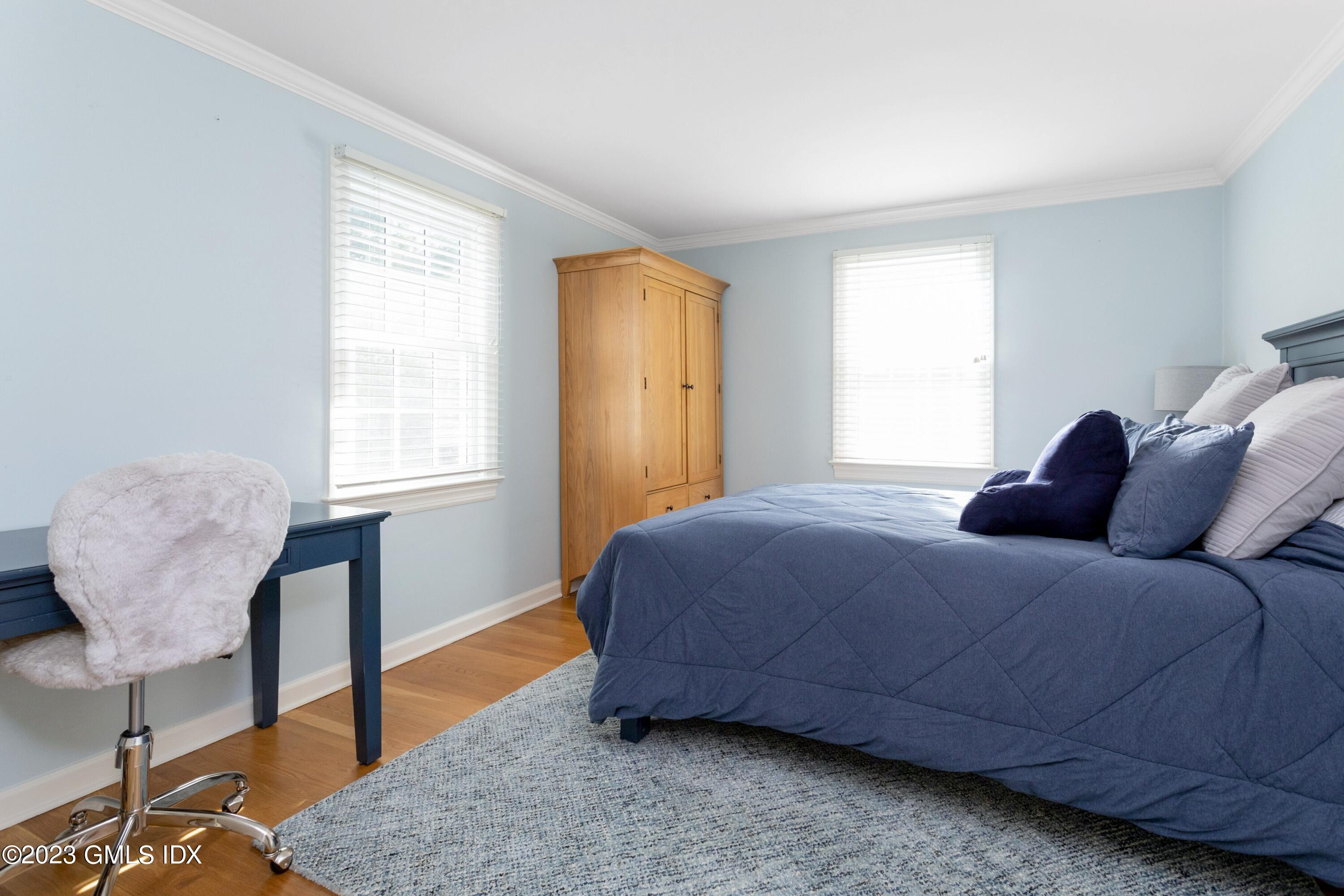 7 Colonial Lane Riverside, CT 06878 - Photo 17 of 27 a bedroom with a bed a table and chair