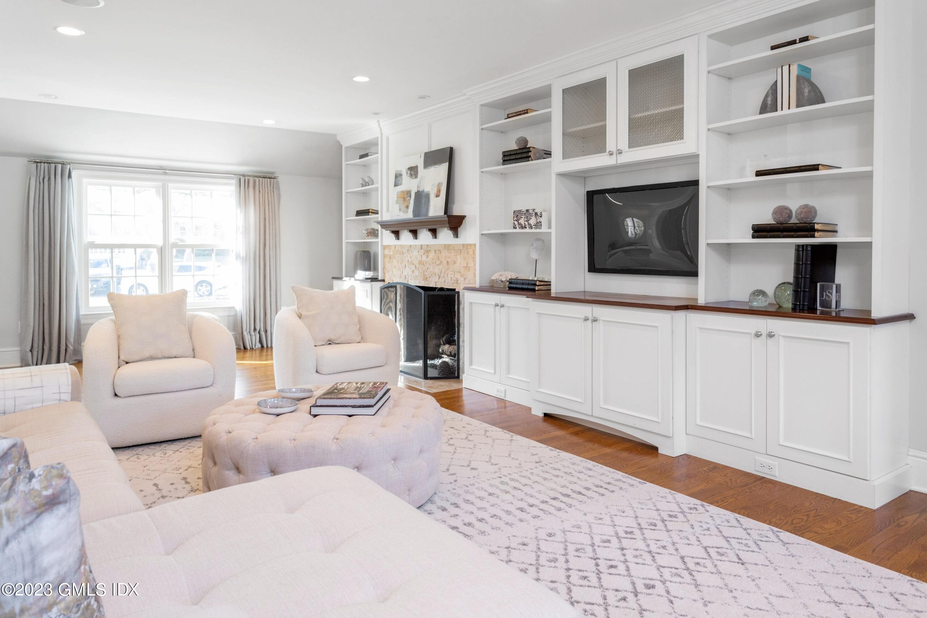 7 Colonial Lane Riverside, CT 06878 - Photo 3 of 27 a living room with furniture a flat screen tv and a fireplace