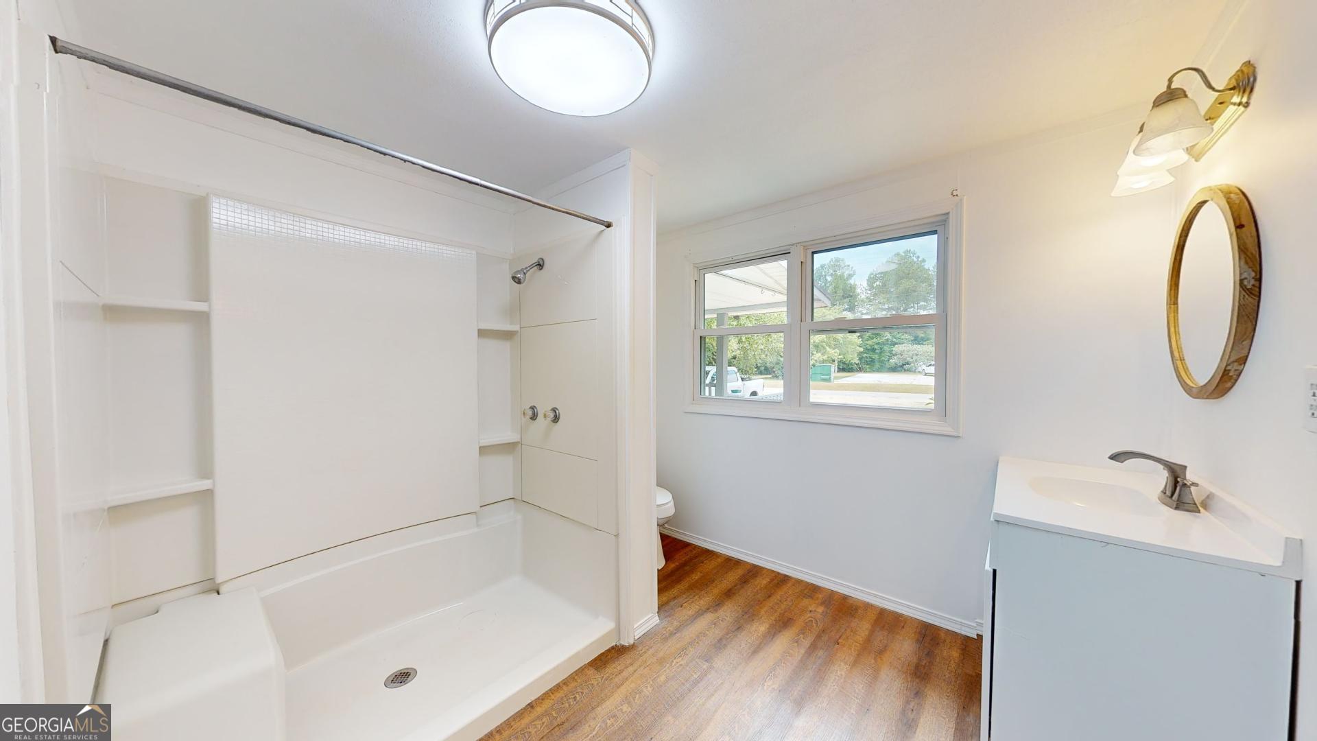 623 Virginia Avenue Millen, GA 30442 - Photo 14 of 34 a bathroom with a tub sink and mirror