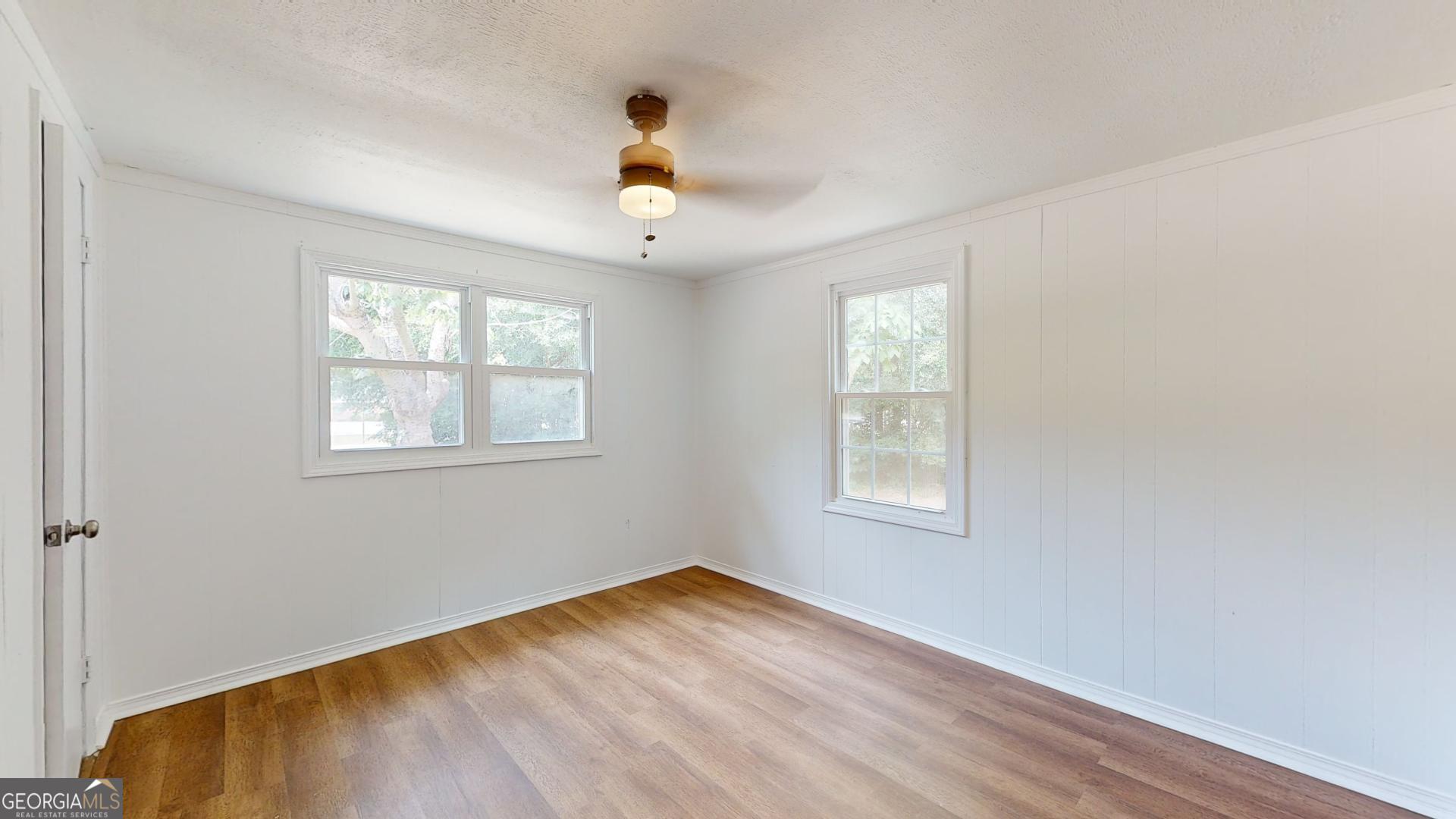 623 Virginia Avenue Millen, GA 30442 - Photo 15 of 34 a view of an empty room with wooden floor and a window