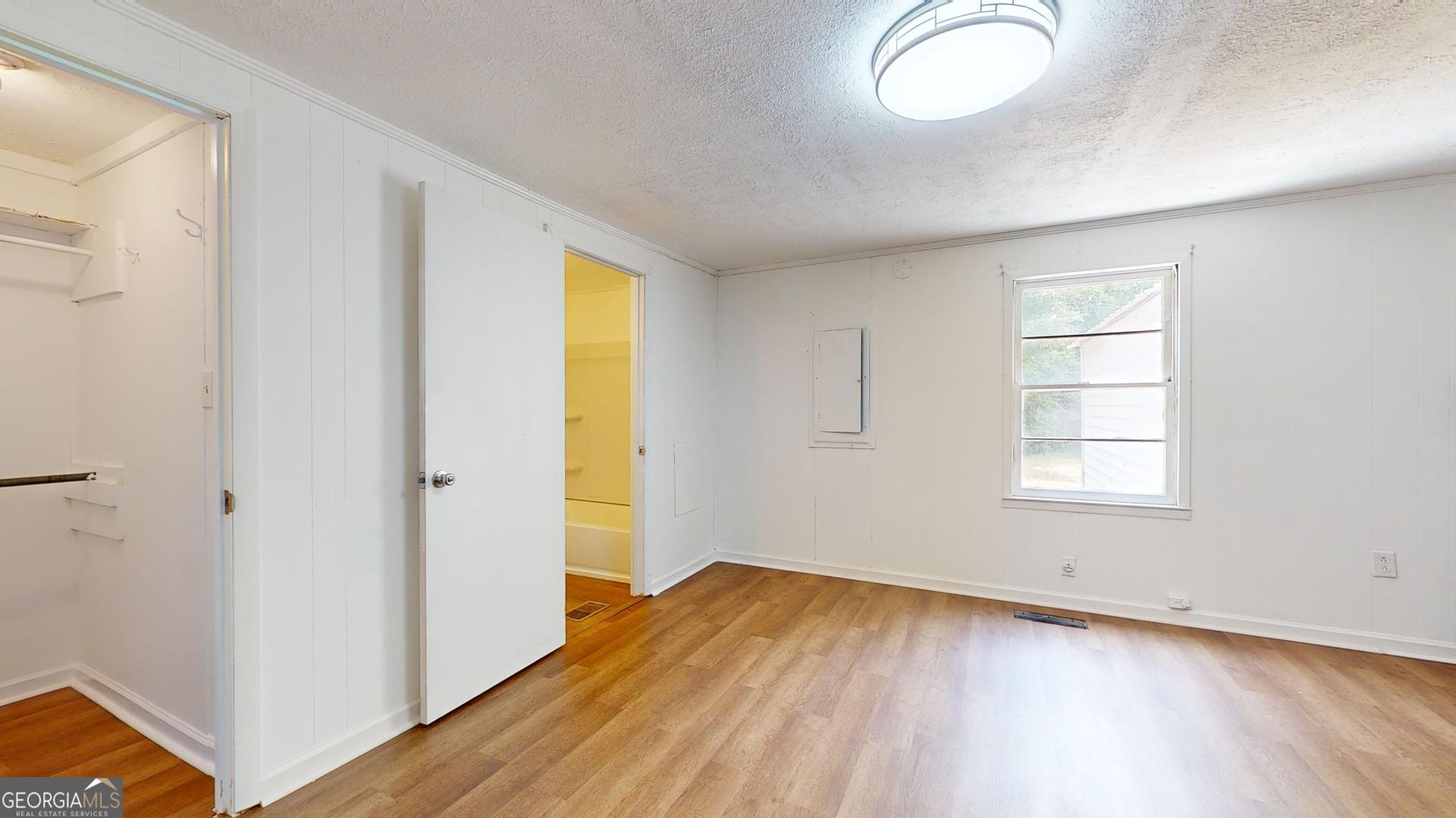 623 Virginia Avenue Millen, GA 30442 - Photo 17 of 34 an empty room with wooden floor and windows
