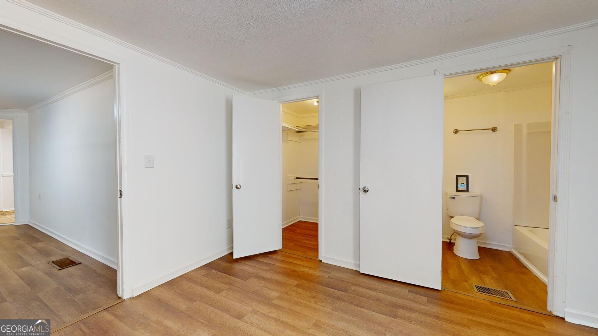 623 Virginia Avenue Millen, GA 30442 - Photo 19 of 34 a view of a room with wooden floor and a bathroom