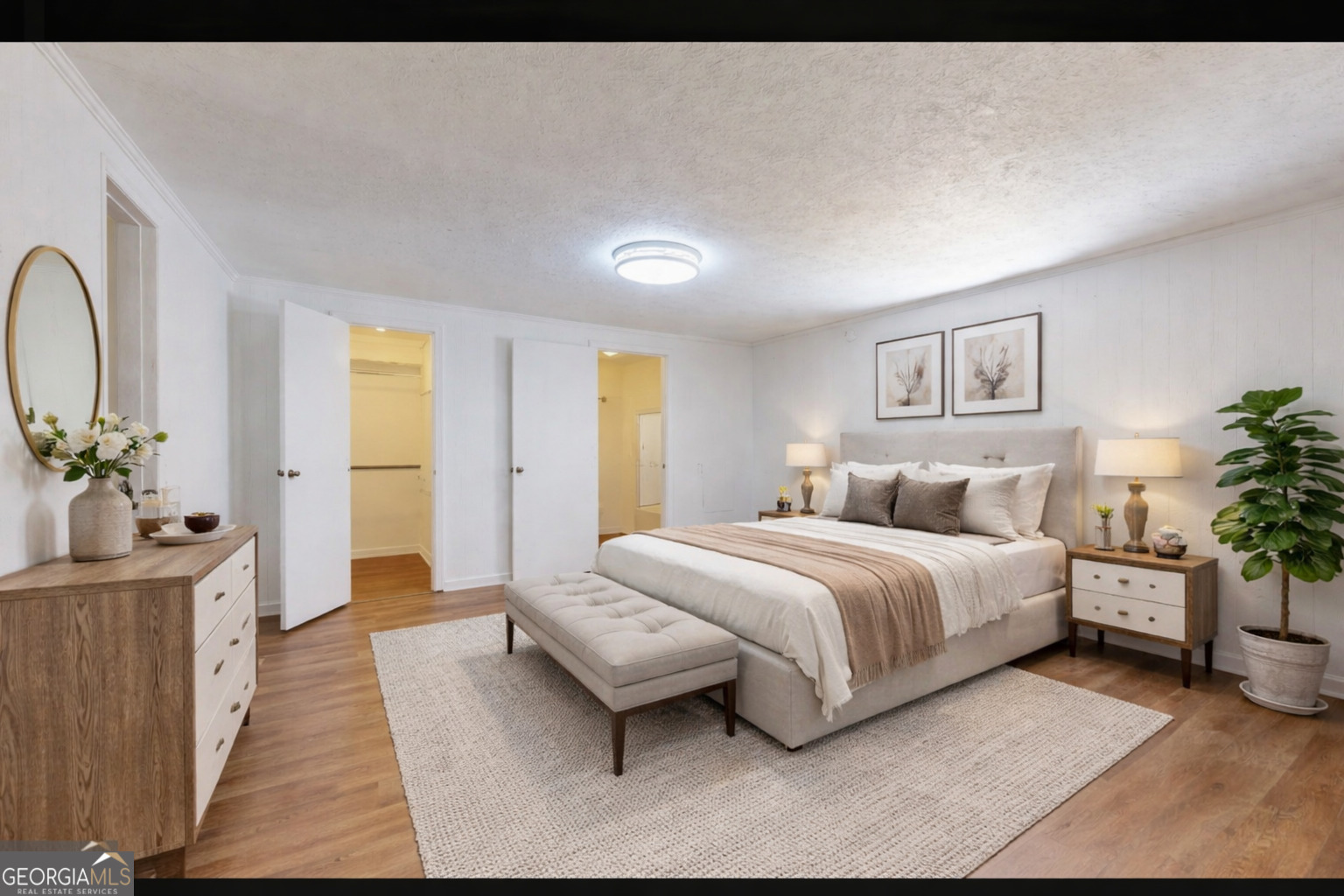 623 Virginia Avenue Millen, GA 30442 - Photo 20 of 34 a spacious bedroom with a bed a couch and potted plant