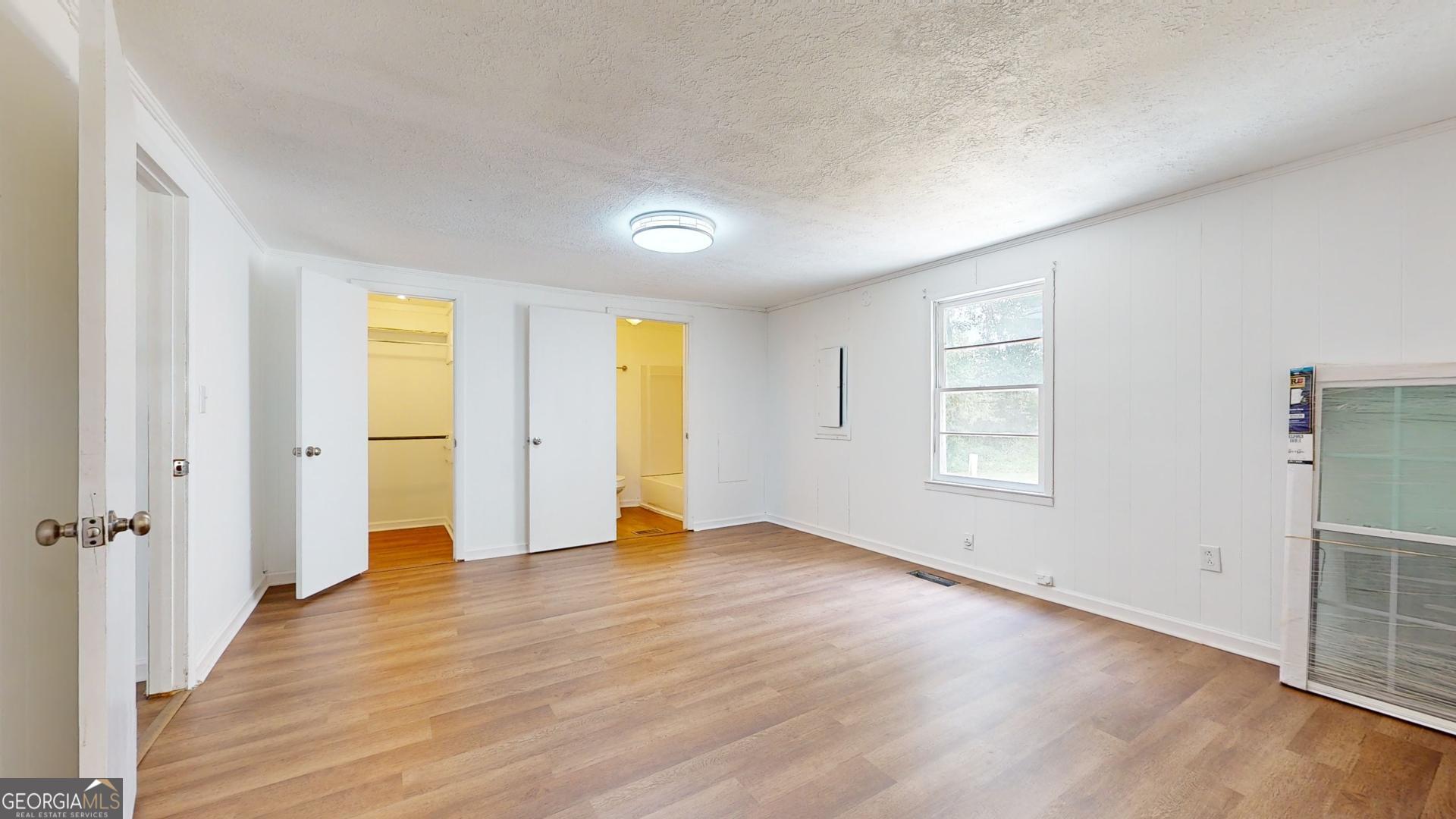 623 Virginia Avenue Millen, GA 30442 - Photo 21 of 34 an empty room with wooden floor and windows