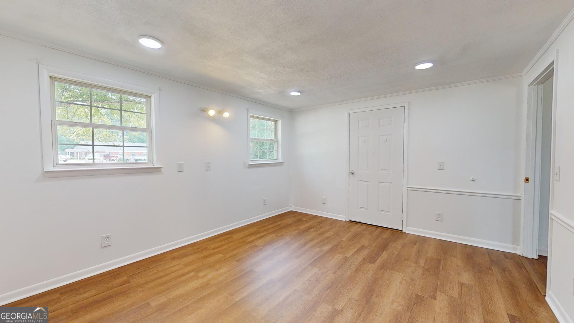 623 Virginia Avenue Millen, GA 30442 - Photo 24 of 34 an empty room with wooden floor and windows