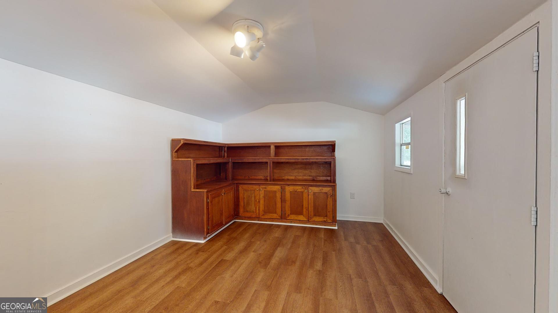 623 Virginia Avenue Millen, GA 30442 - Photo 26 of 34 wooden floor in an empty room with a window