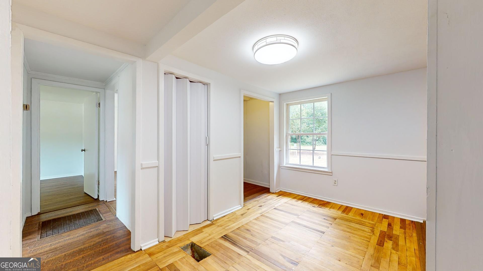 623 Virginia Avenue Millen, GA 30442 - Photo 6 of 34 a view of empty room with wooden floor and fan