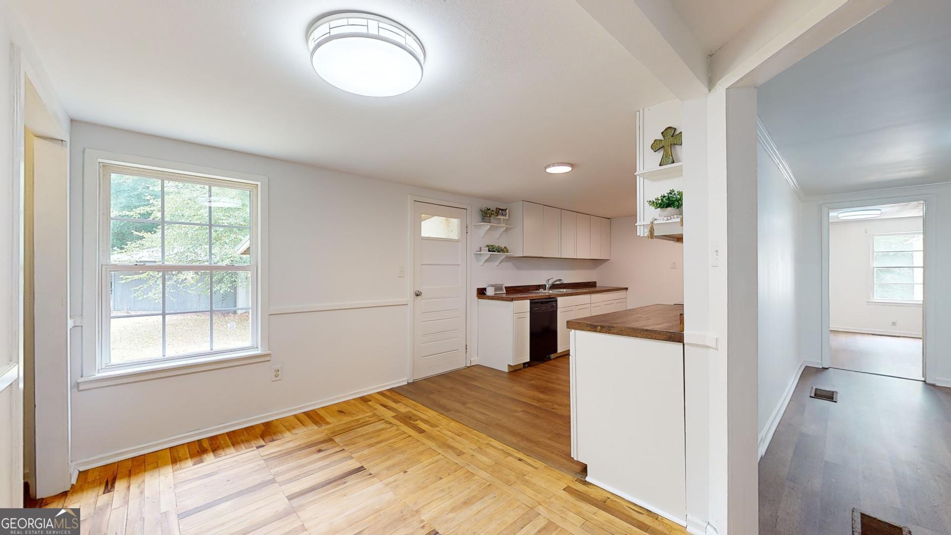 623 Virginia Avenue Millen, GA 30442 - Photo 8 of 34 a kitchen with a refrigerator and windows