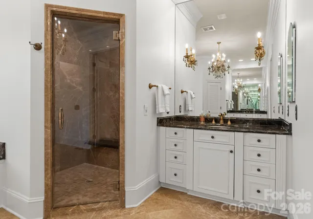 a bathroom with a granite countertop sink mirror and shower
