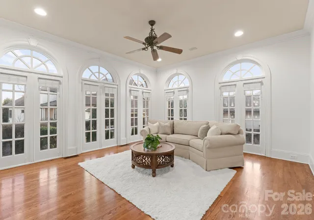 a living room with furniture potted plant and a large window