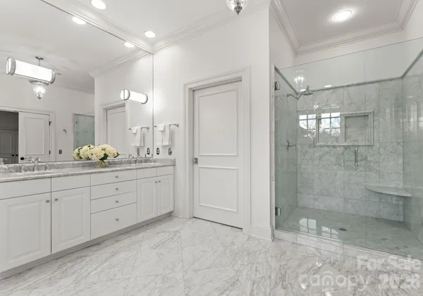 a spacious bathroom with a granite countertop sink mirror and shower