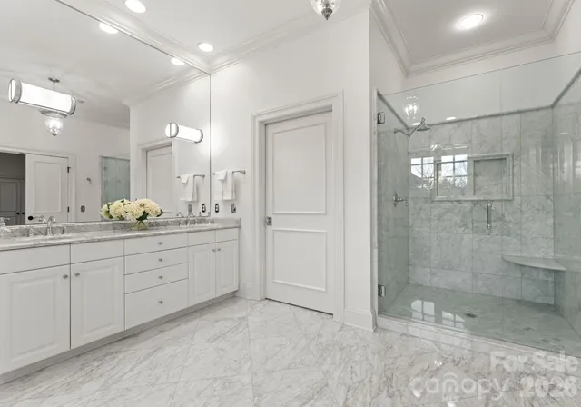 a spacious bathroom with a granite countertop sink mirror and shower