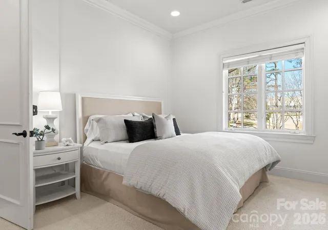 a bedroom with bed and window