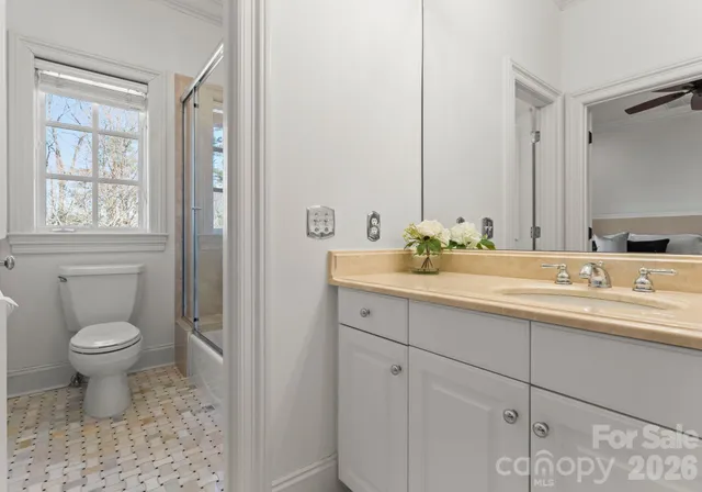 a bathroom with a sink toilet and shower