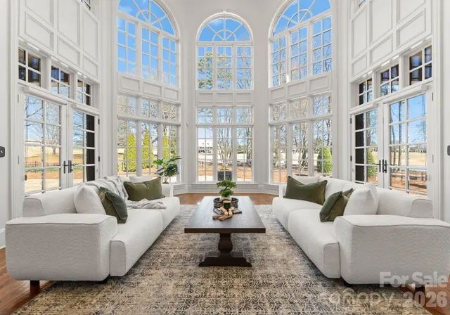 a living room with furniture fireplace and a large window