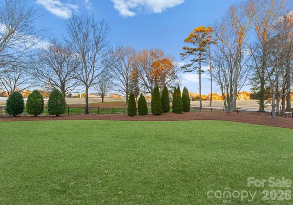 a view of outdoor space with garden and trees