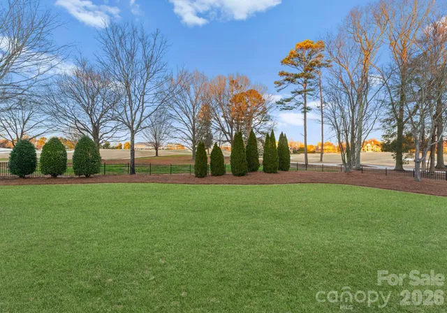 a view of outdoor space with garden and trees