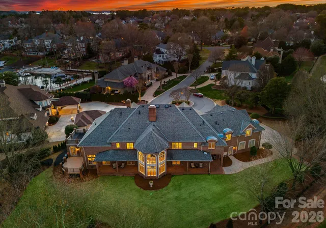 an aerial view of a house with garden space and street view