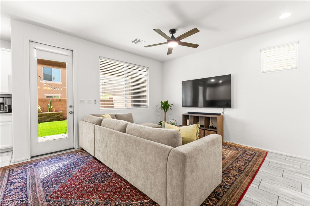 6435 Point Isabel Way Las Vegas, NV 89122 - Photo 8 of 57 A comfortable living space offers seamless indoor-outdoor access to a charming backyard.