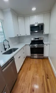 a kitchen with granite countertop a stove and a sink