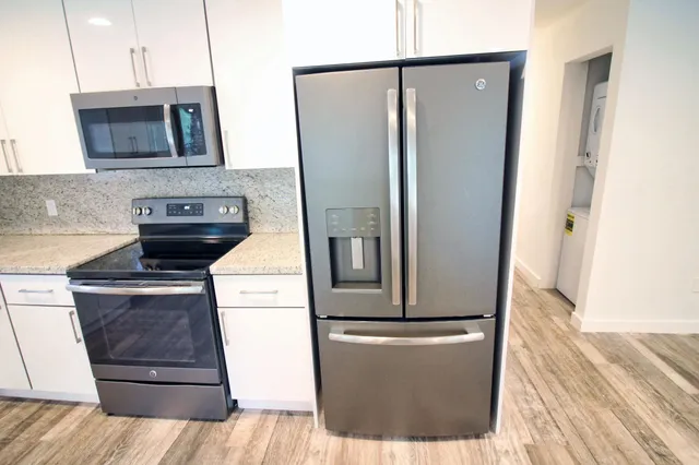 a kitchen with a refrigerator and a stove