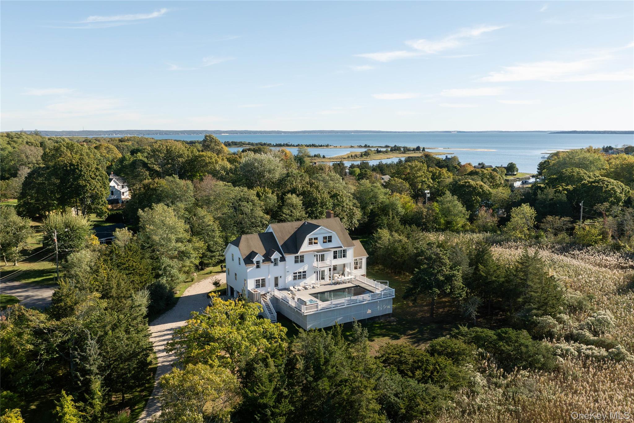 an aerial view of a house with a yard and lake view