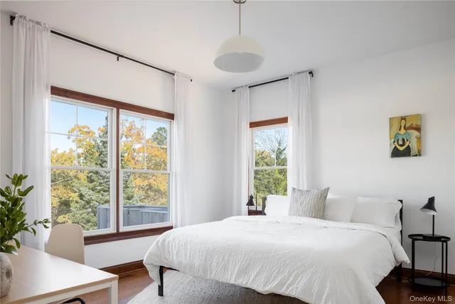 a bedroom with a large bed and a window