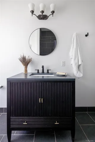 a kitchen with a sink a stove and a mirror