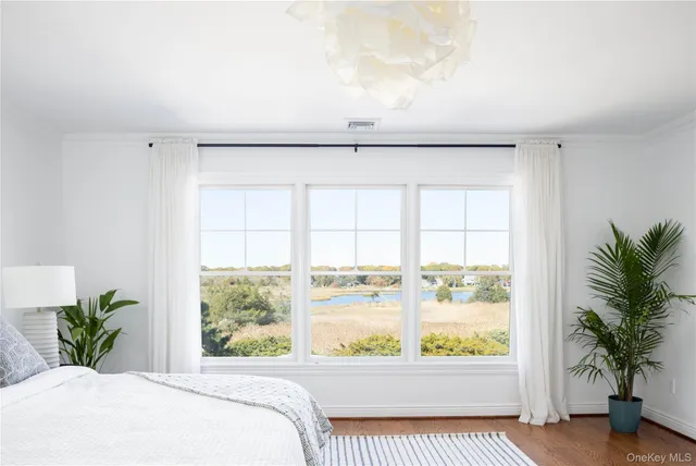 a view of a room that has a bed and a large window