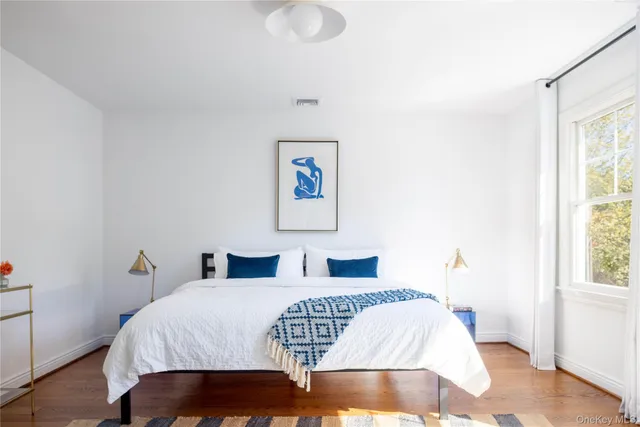 a bedroom with a bed and a window