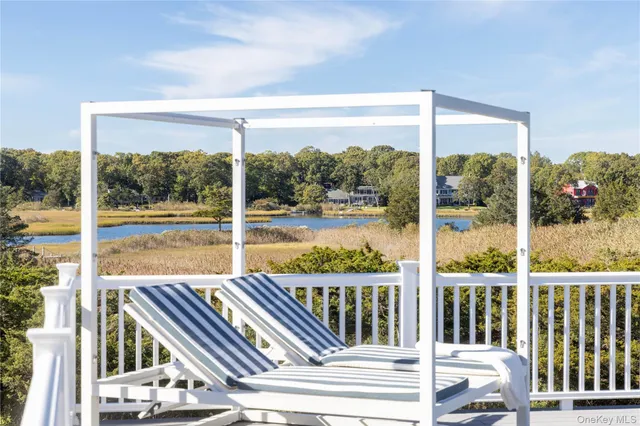 a view of a balcony with lake view and wooden floor