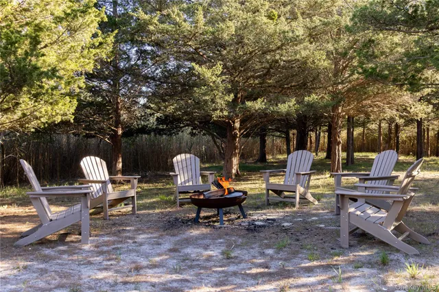 a backyard of a house with barbeque oven and outdoor seating