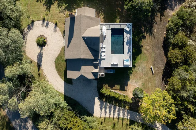 an aerial view of a house with a yard