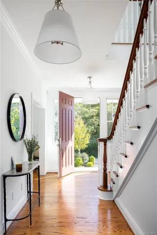 a view of an entryway with wooden floor and front door