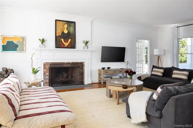 a living room with furniture a fireplace and a flat screen tv
