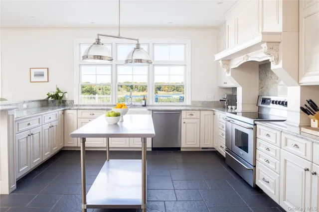 a kitchen with a white cabinets stove and sink