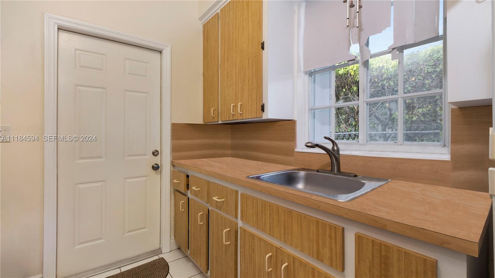 535 West 51st Street Miami Beach, FL 33140 - Photo 13 of 40 a kitchen with a sink and a window