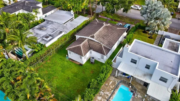 an aerial view of a house with garden space and street view