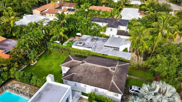 an aerial view of a house with a garden and swimming pool