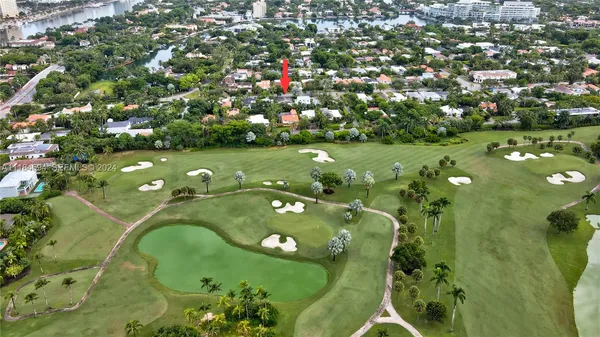 an aerial view of residential houses with outdoor space and street view