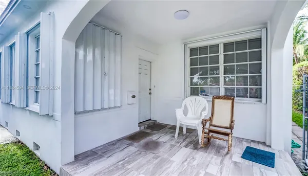 a view of a room with wooden floor and chair